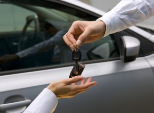 woman receiving car key from man